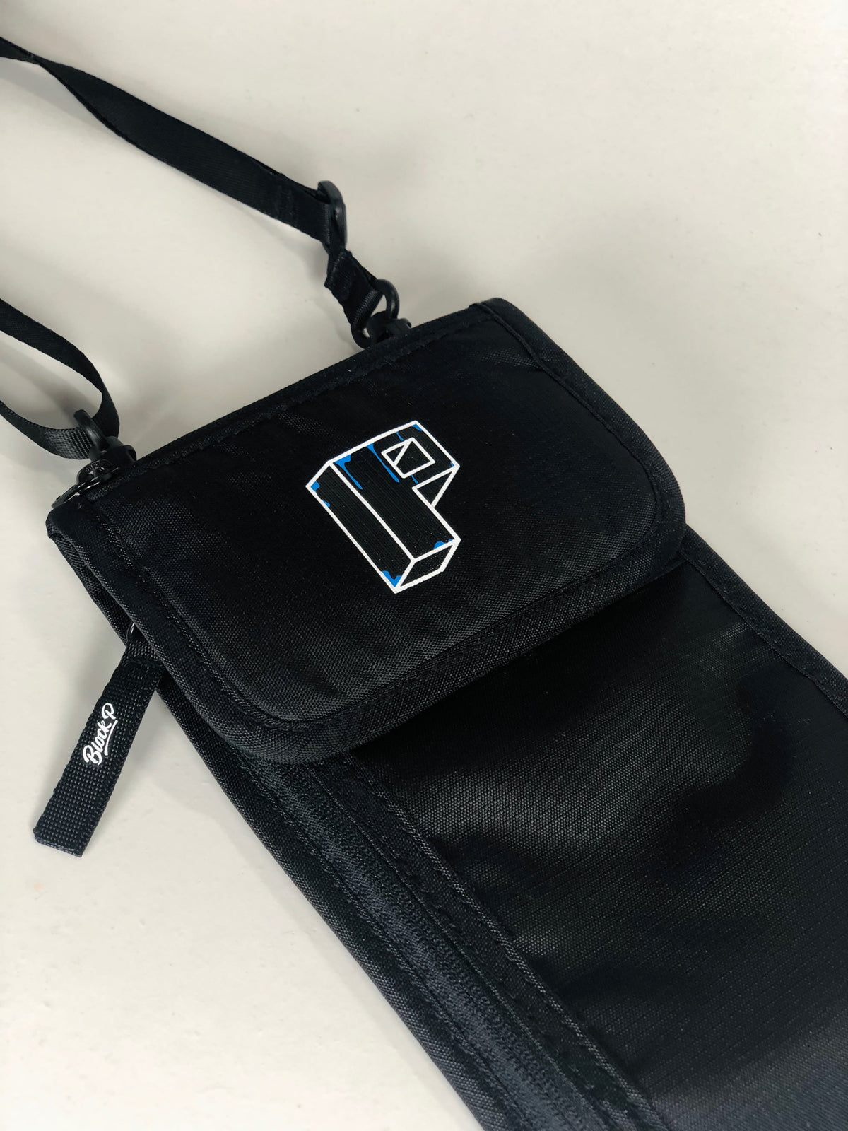 Block P Neck Pouch worn over shoulder — festival and travel bag